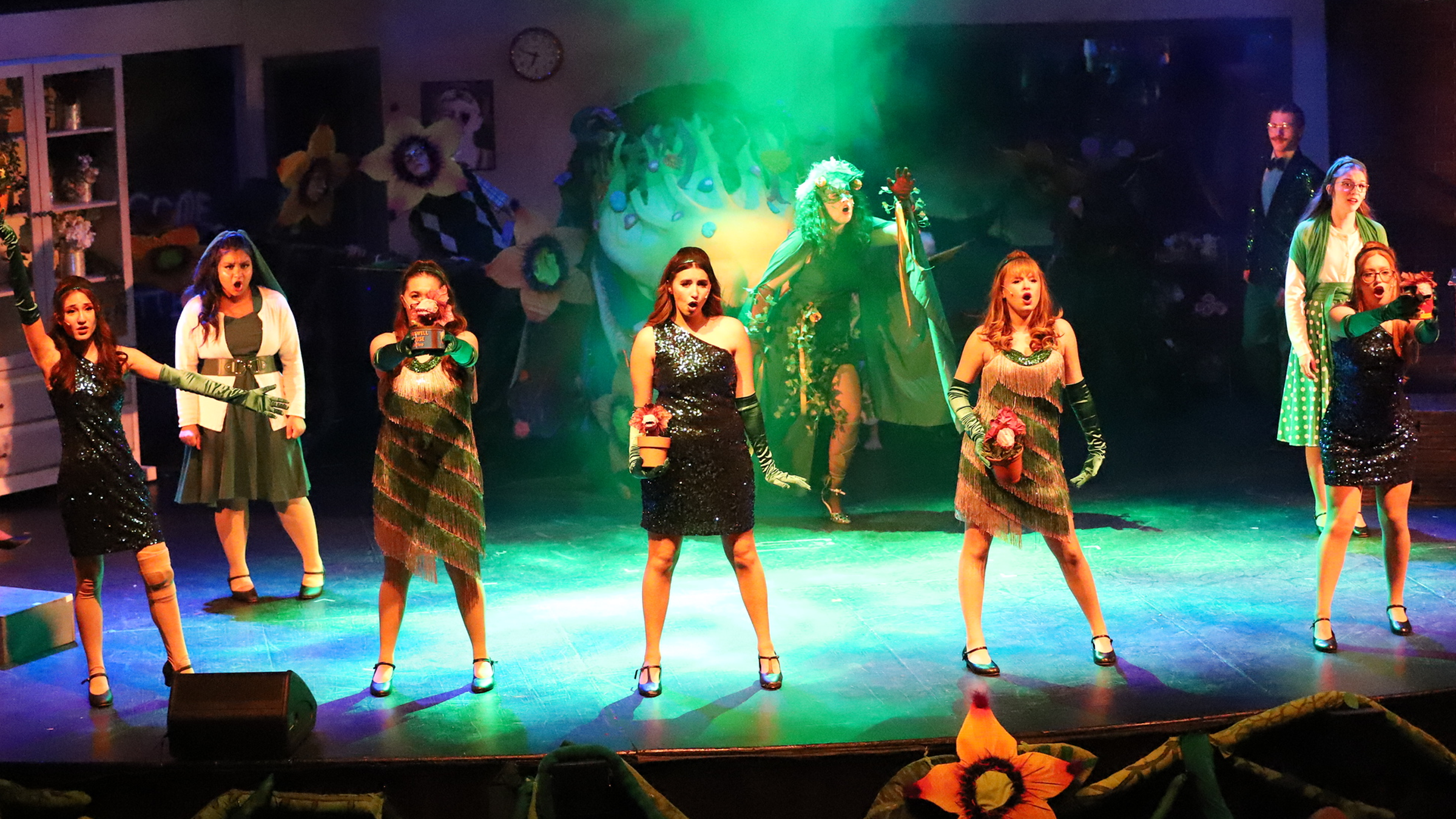Performers standing in a theatrical spotlight